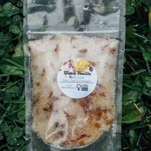 Bath soak package laying in wet clover.